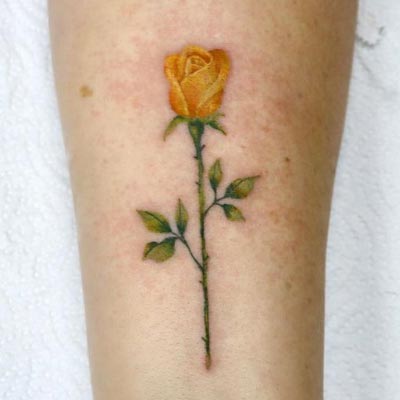 Sydney loves to do single flower tattoos with color.